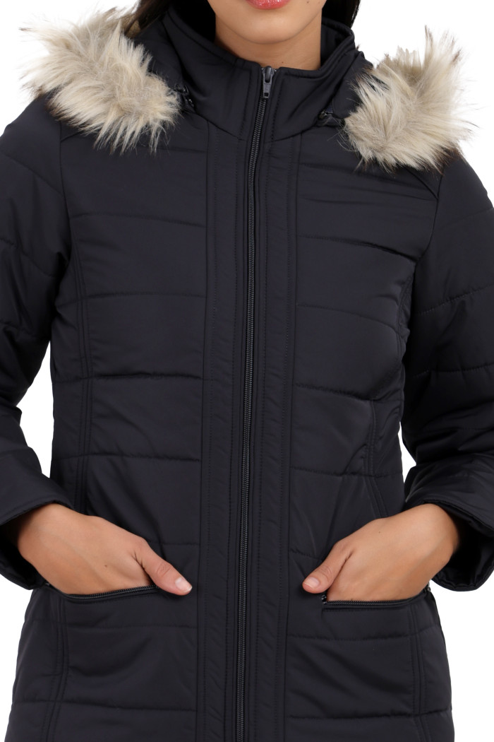 A cropped image of a woman wearing Trufit’s dark grey Matte Quilted Jacket with Horizontal Pockets, zip closure, and a removable hood with both hands in the pocket.